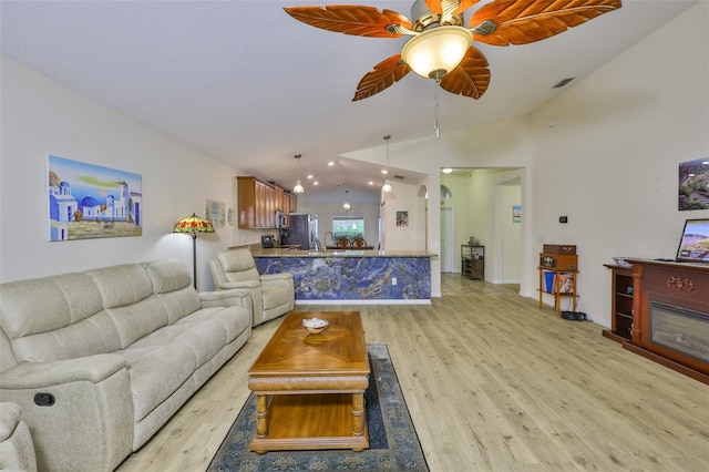 15403 Fire Rock Pl, Ruskin, FL 33573 - living area featuring lofted ceiling, light wood-type flooring, and ceiling fan