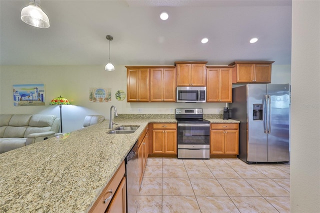 15403 Fire Rock Pl, Ruskin, FL 33573 - kitchen with stainless steel appliances, brown cabinetry, pendant lighting, and recessed lighting