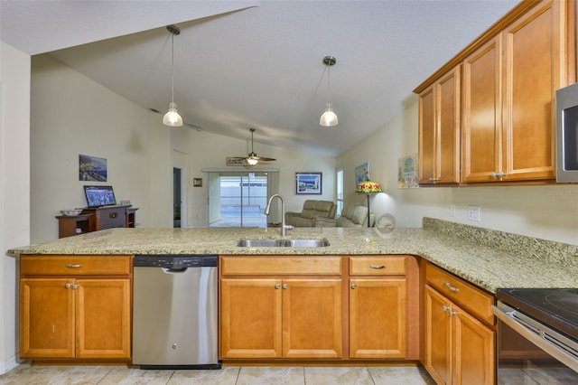 15403 Fire Rock Pl, Ruskin, FL 33573 - kitchen with stainless steel dishwasher, lofted ceiling, a peninsula, brown cabinets, and ceiling fan
