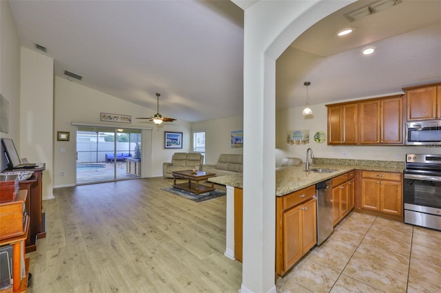 15403 Fire Rock Pl, Ruskin, FL 33573 - kitchen with stainless steel appliances, lofted ceiling, open floor plan, ceiling fan, and light stone counters