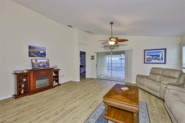 15403 Fire Rock Pl, Ruskin, FL 33573 - living area featuring light wood finished floors, a ceiling fan, and lofted ceiling