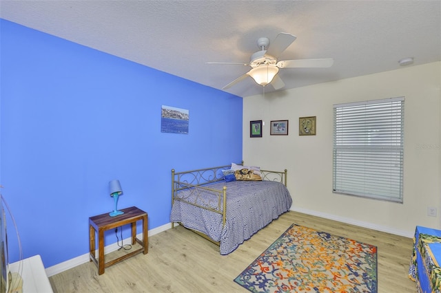 15403 Fire Rock Pl, Ruskin, FL 33573 - bedroom with wood finished floors, ceiling fan, and a textured ceiling