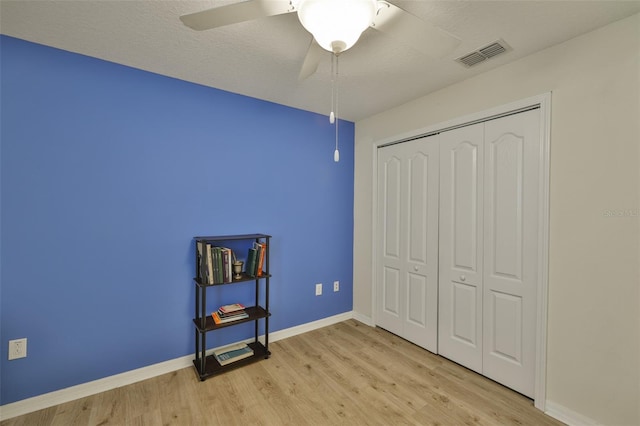 15403 Fire Rock Pl, Ruskin, FL 33573 - unfurnished bedroom featuring light wood-style floors, a closet, and ceiling fan