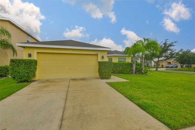 15403 Fire Rock Pl, Ruskin, FL 33573 - view of front facade with concrete driveway, stucco siding, a front yard, and a garage