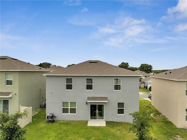 2023 Maple Ridge Dr, Zellwood, FL 32798 - rear view of property featuring a lawn, roof with shingles, and stucco siding