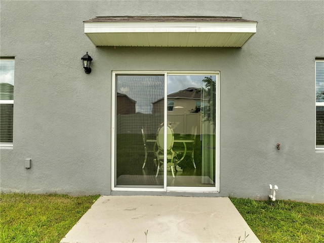 2023 Maple Ridge Dr, Zellwood, FL 32798 - entrance to property with stucco siding and a patio