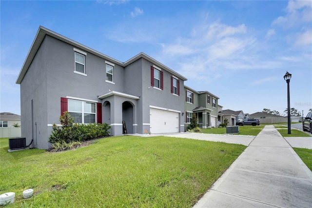 2023 Maple Ridge Dr, Zellwood, FL 32798 - view of front of home with an attached garage, stucco siding, a residential view, and a front lawn