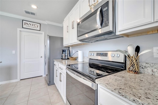 2023 Maple Ridge Dr, Zellwood, FL 32798 - kitchen with appliances with stainless steel finishes, ornamental molding, white cabinets, and light stone countertops