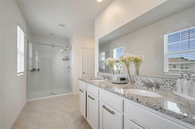 2023 Maple Ridge Dr, Zellwood, FL 32798 - full bathroom featuring a shower stall, double vanity, tile patterned floors, and plenty of natural light
