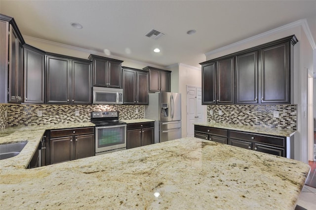 2605 Stardale Way, Lutz, FL 33558 - kitchen with stainless steel appliances, light stone counters, ornamental molding, dark brown cabinetry, and backsplash