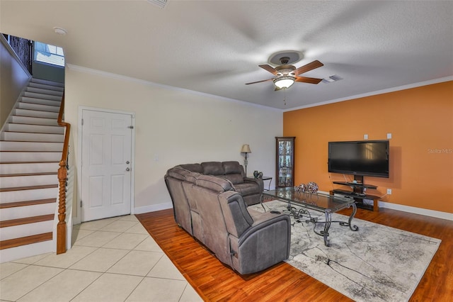 2605 Stardale Way, Lutz, FL 33558 - living room with ceiling fan, stairway, crown molding, wood finished floors, and a textured ceiling