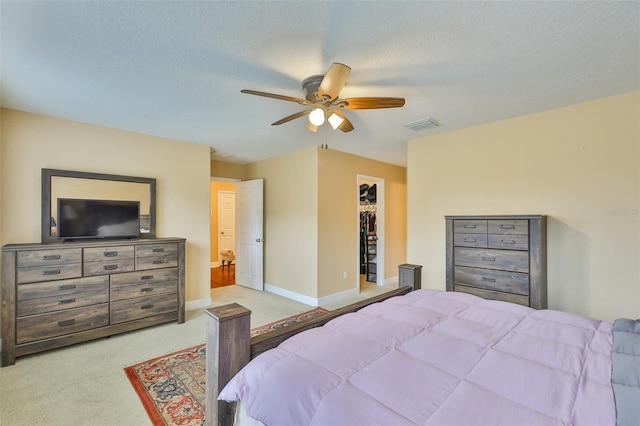 2605 Stardale Way, Lutz, FL 33558 - carpeted bedroom with ceiling fan, a spacious closet, a closet, and a textured ceiling