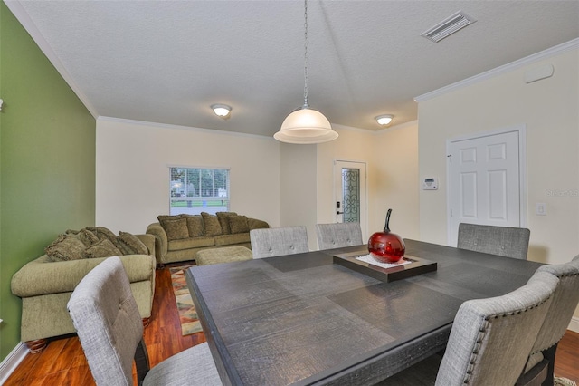 2605 Stardale Way, Lutz, FL 33558 - dining area with wood finished floors, ornamental molding, and a textured ceiling