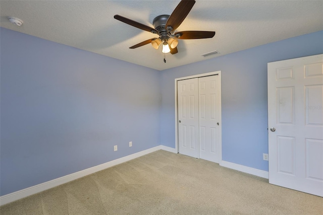 2605 Stardale Way, Lutz, FL 33558 - unfurnished bedroom with carpet, a closet, and a ceiling fan