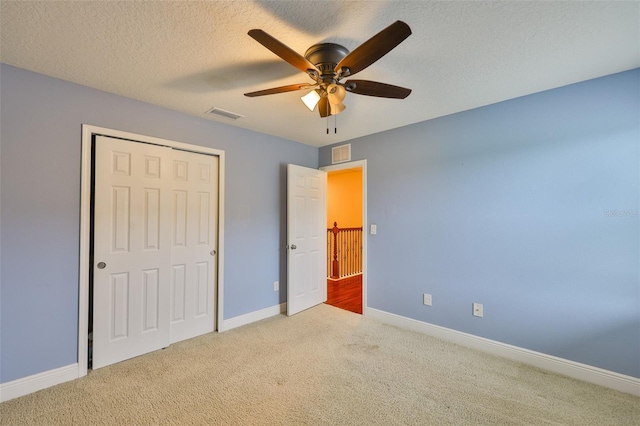 2605 Stardale Way, Lutz, FL 33558 - unfurnished bedroom with carpet floors, a closet, a ceiling fan, and a textured ceiling