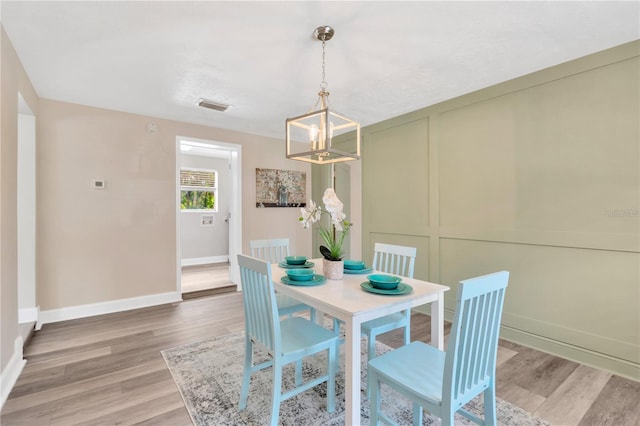 4723 Bloomingdale Ave, Valrico, FL 33596 - dining space with a chandelier and light wood-style floors
