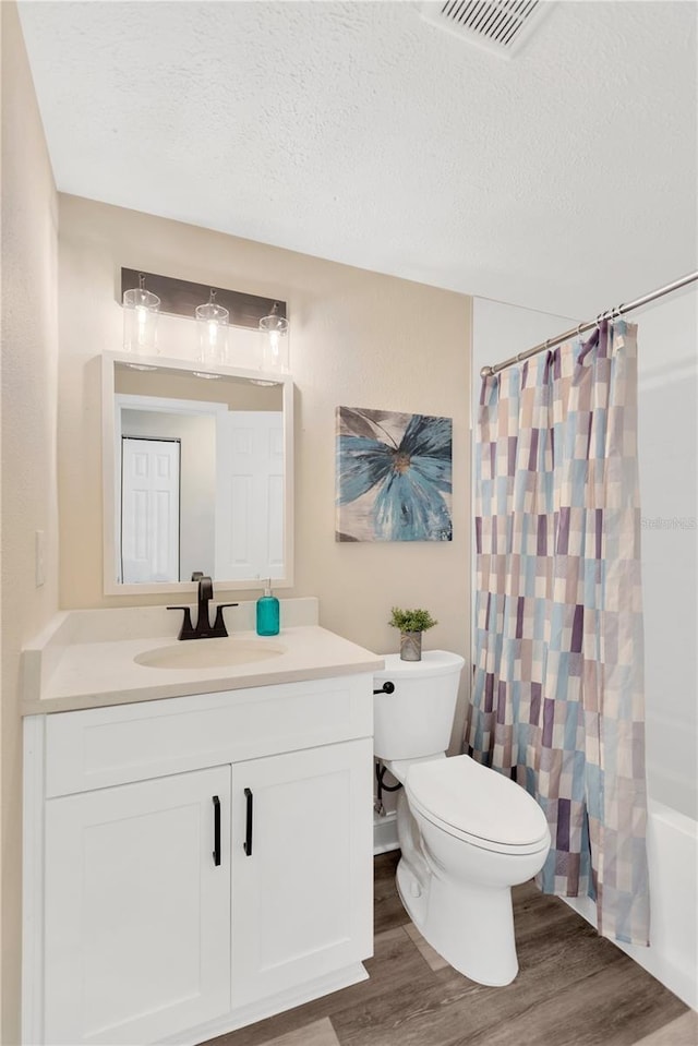 4723 Bloomingdale Ave, Valrico, FL 33596 - full bathroom with vanity, wood finished floors, a textured ceiling, and shower / bath combo