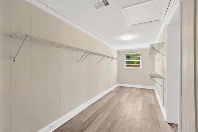 4723 Bloomingdale Ave, Valrico, FL 33596 - walk in closet featuring wood finished floors and attic access
