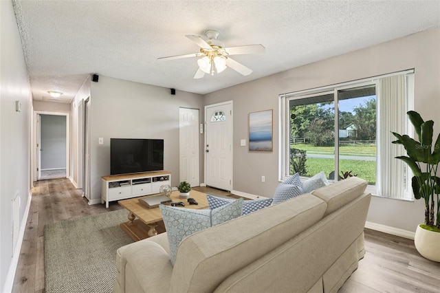 923 April Hills Blvd, Lady Lake, FL 32159 - living area featuring a textured ceiling, wood finished floors, and ceiling fan