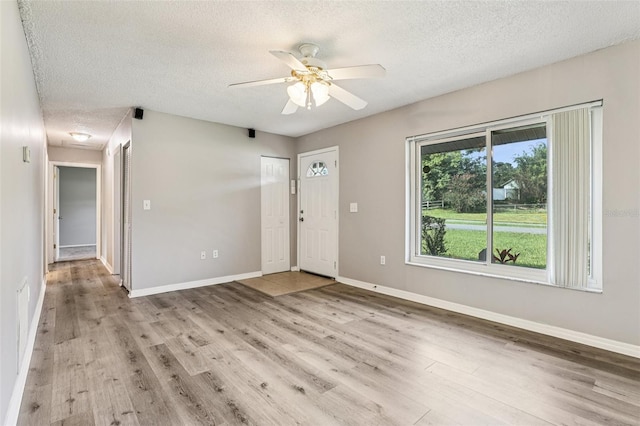 923 April Hills Blvd, Lady Lake, FL 32159 - foyer entrance with a textured ceiling, wood finished floors, and ceiling fan