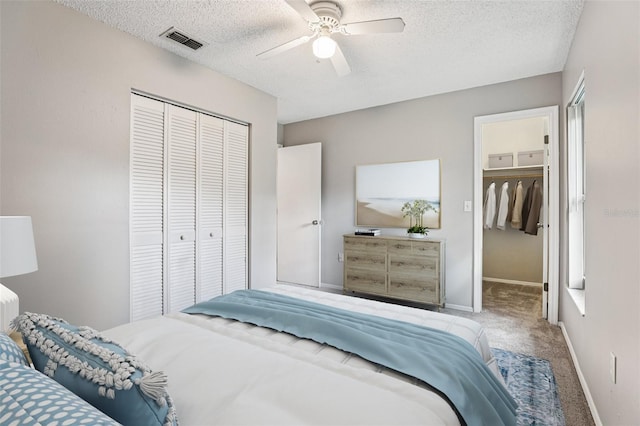 923 April Hills Blvd, Lady Lake, FL 32159 - carpeted bedroom with a textured ceiling and a ceiling fan