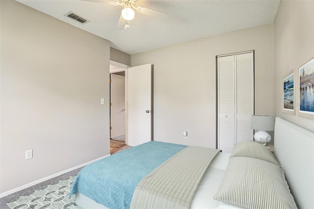 923 April Hills Blvd, Lady Lake, FL 32159 - bedroom with carpet, a closet, a textured ceiling, and a ceiling fan