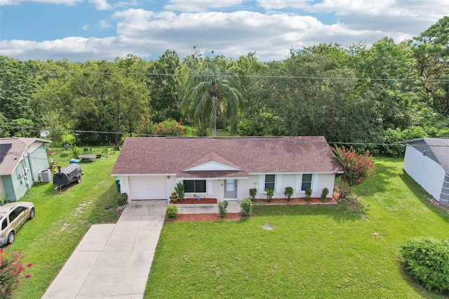 923 April Hills Blvd, Lady Lake, FL 32159 - ranch-style house featuring driveway, an attached garage, a front yard, and a view of trees