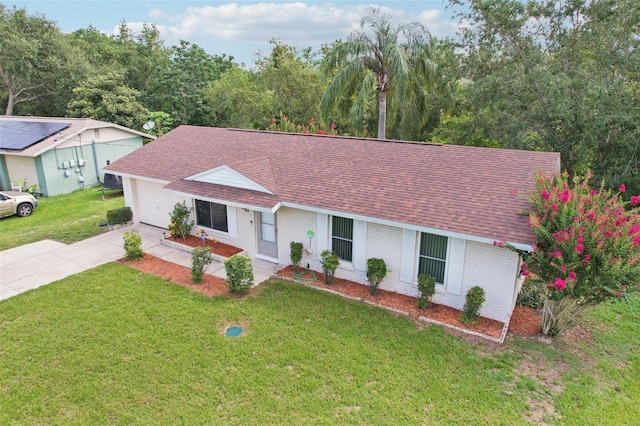 923 April Hills Blvd, Lady Lake, FL 32159 - single story home featuring roof with shingles, driveway, brick siding, an attached garage, and a front yard