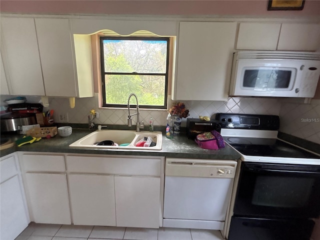 16107 Sea Pines Dr, Hudson, FL 34667 - kitchen featuring white appliances, white cabinetry, backsplash, and dark countertops
