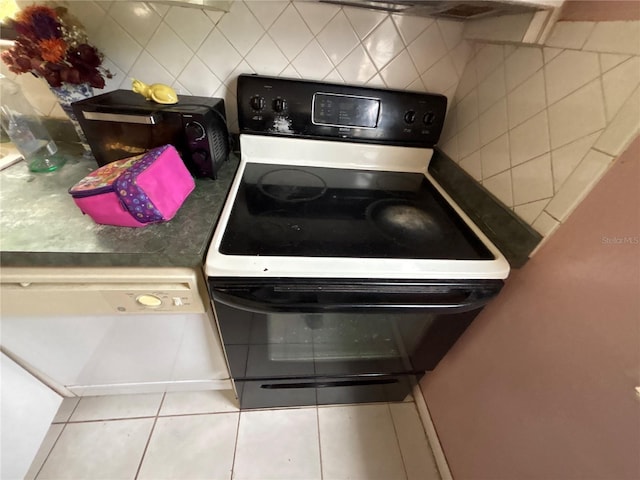 16107 Sea Pines Dr, Hudson, FL 34667 - kitchen with electric range and tile patterned flooring