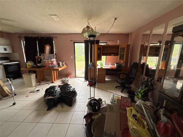 16107 Sea Pines Dr, Hudson, FL 34667 - living room with an office area, light tile patterned flooring, and a textured ceiling