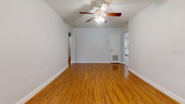 8609 N 11th St, Tampa, FL 33604 - empty room with light wood-style floors and ceiling fan