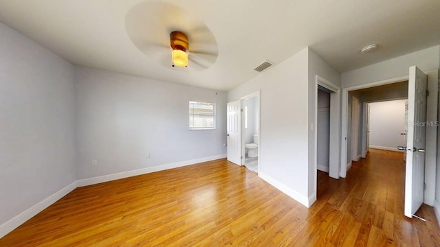 8609 N 11th St, Tampa, FL 33604 - spare room featuring light wood-style flooring, ceiling fan, and a smoke detector