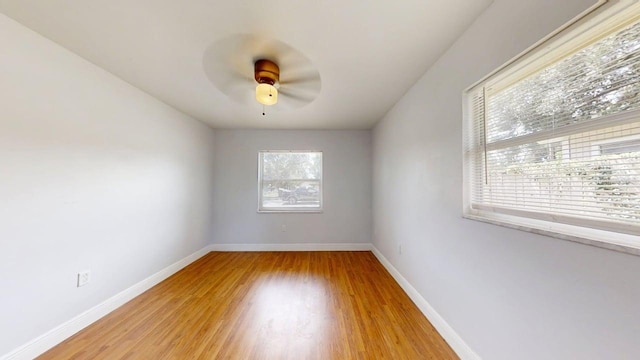 8609 N 11th St, Tampa, FL 33604 - spare room featuring light wood-style flooring and a ceiling fan