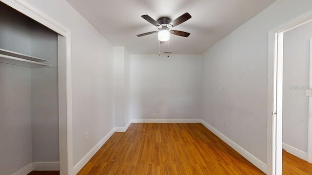 8609 N 11th St, Tampa, FL 33604 - unfurnished bedroom with wood finished floors, a closet, and ceiling fan