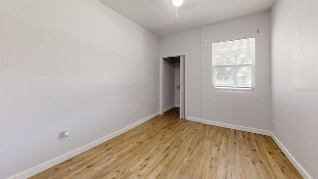 8609 N 11th St, Tampa, FL 33604 - unfurnished bedroom with light wood finished floors, a closet, and ceiling fan