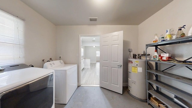 8609 N 11th St, Tampa, FL 33604 - washroom with electric water heater and washing machine and dryer