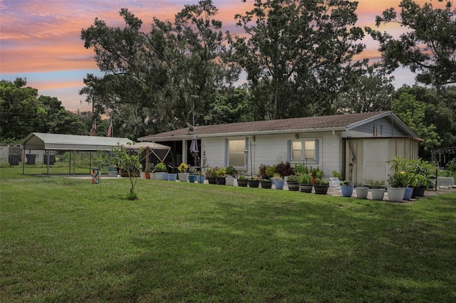 127 Locke Rd, Davenport, FL 33837 - back of property featuring a detached carport and a lawn