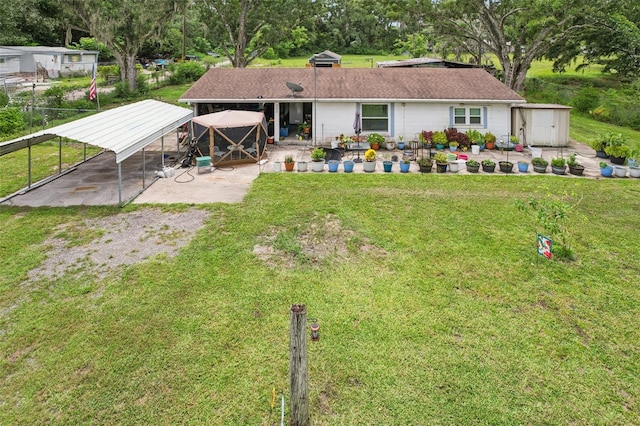 127 Locke Rd, Davenport, FL 33837 - rear view of property featuring a shed, a yard, and a carport