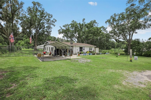 127 Locke Rd, Davenport, FL 33837 - view of yard featuring a detached carport, view of wooded area, and a patio