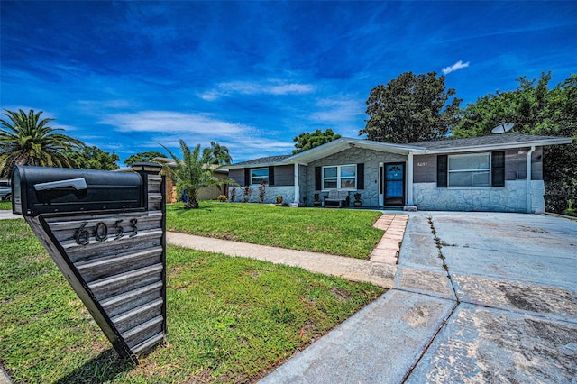 6053 11th Ave, New Port Richey, FL 34653 - ranch-style home with stone siding, a front lawn, and concrete driveway