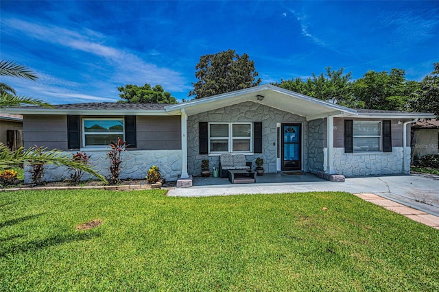 6053 11th Ave, New Port Richey, FL 34653 - ranch-style house featuring a front yard, stone siding, and a porch