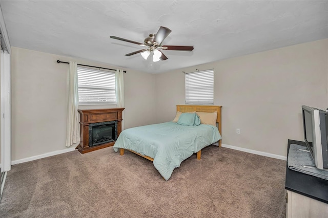 6053 11th Ave, New Port Richey, FL 34653 - carpeted bedroom featuring a glass covered fireplace and ceiling fan