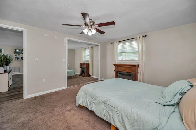 6053 11th Ave, New Port Richey, FL 34653 - bedroom with a glass covered fireplace, carpet flooring, ceiling fan, and a closet