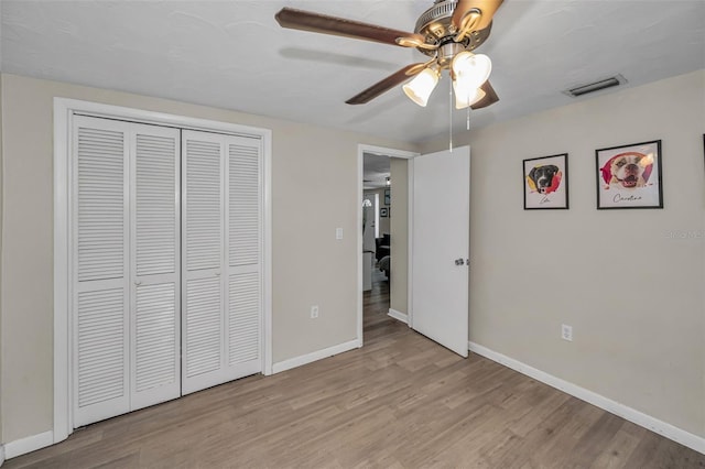 6053 11th Ave, New Port Richey, FL 34653 - unfurnished bedroom featuring wood finished floors, a closet, and ceiling fan