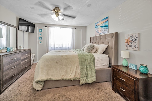 6053 11th Ave, New Port Richey, FL 34653 - bedroom with light carpet and a ceiling fan