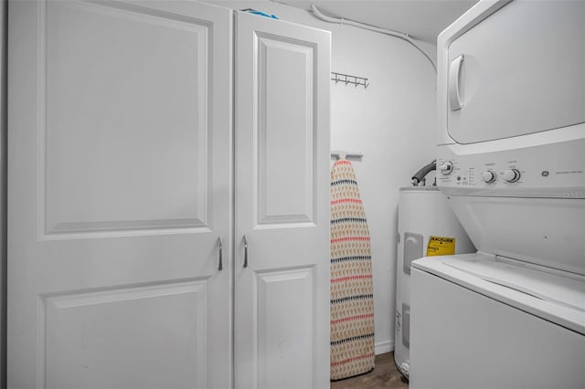 6053 11th Ave, New Port Richey, FL 34653 - laundry room featuring stacked washer / dryer, electric water heater, and cabinet space