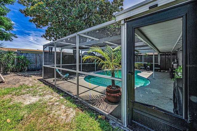 6053 11th Ave, New Port Richey, FL 34653 - view of pool featuring a fenced backyard, a patio area, and glass enclosure