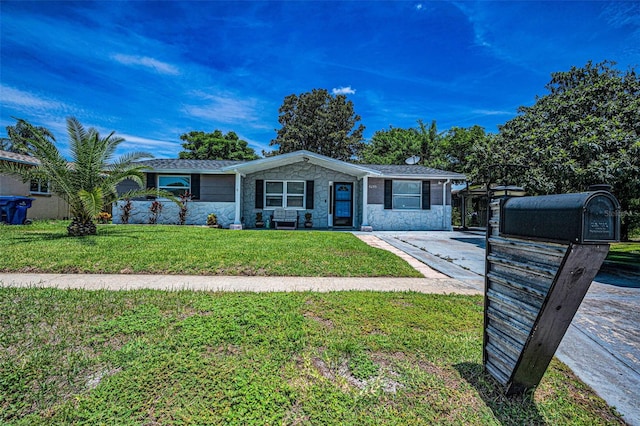 6053 11th Ave, New Port Richey, FL 34653 - view of front of home featuring stone siding and a front lawn