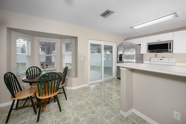 10807 Shasta Ct, Riverview, FL 33569 - kitchen with stainless steel appliances, light countertops, and white cabinetry